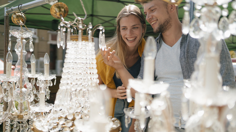 Two people shopping for chandeliers