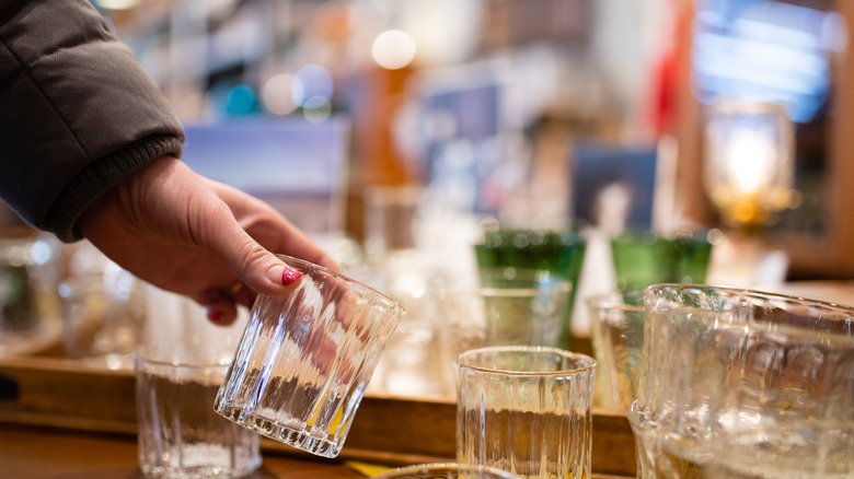 person holding secondhand drinking glass