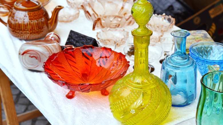 Set of glass decanter jug, glassware vase, fruit stand old vintage glassware garage sale on flea market.