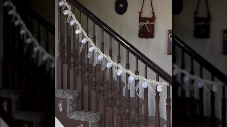 Lacy Easter garland with blue eggs hangs on a stair railing