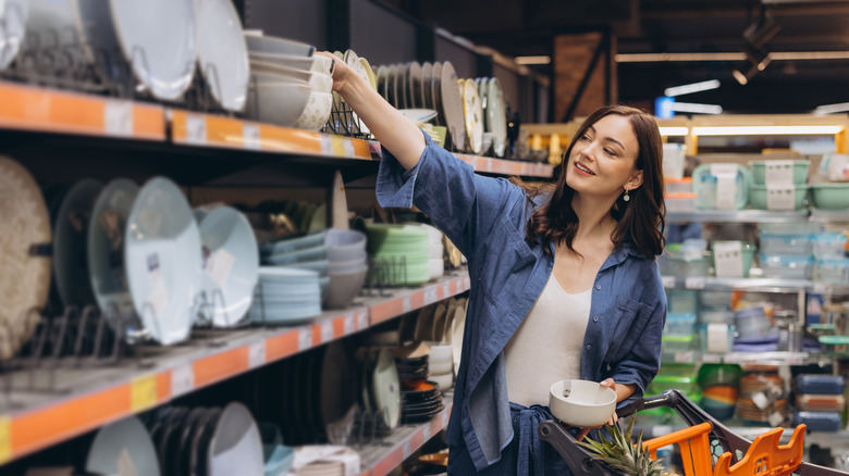 A woman shops for bowls and other dishware