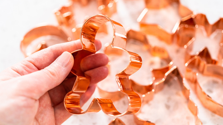 Person holding copper cookie cutter