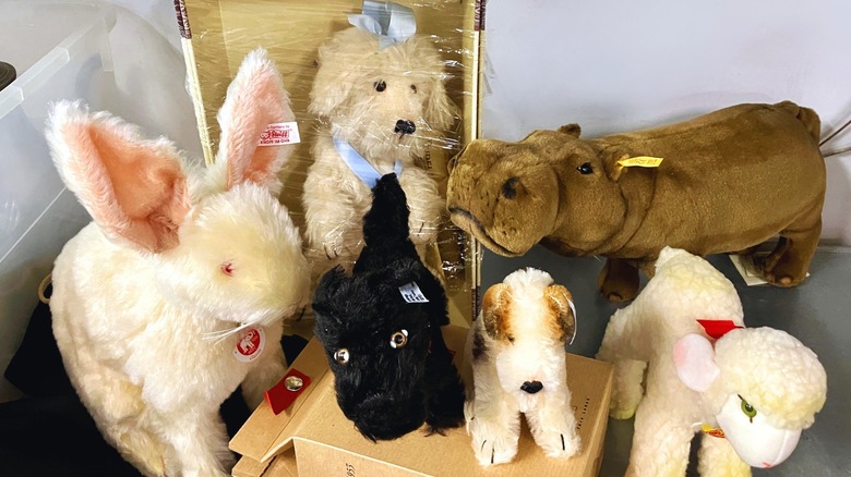 A collection of collectible and vintage Steiff animals with tags on their ears