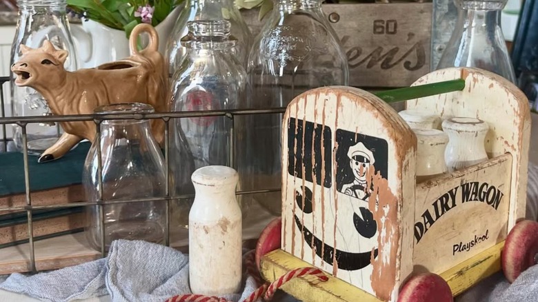 Tan cow creamer styled with other vintage milk finds.