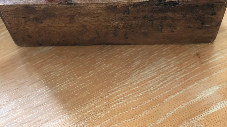 Colored pens, pencils, and crayons stored in a vintage wooden sugar mold.