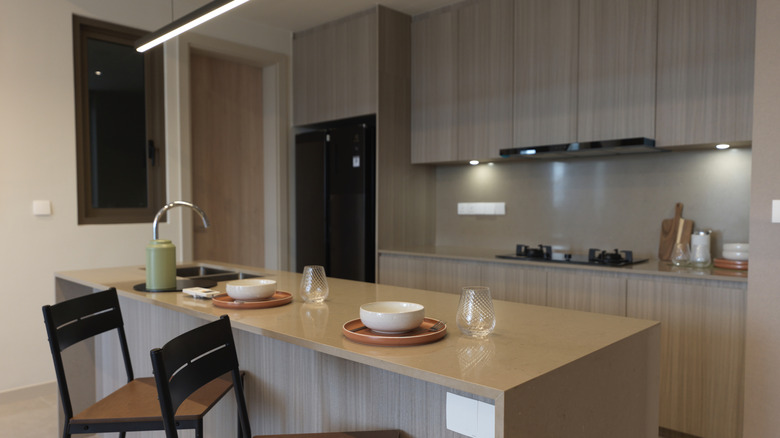 Woman in vintage style U-shaped kitchen