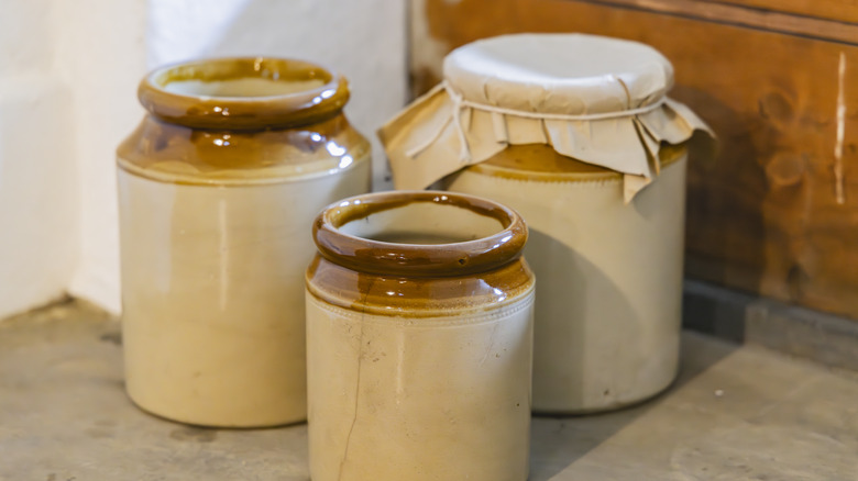 Three beige stoneware crocks