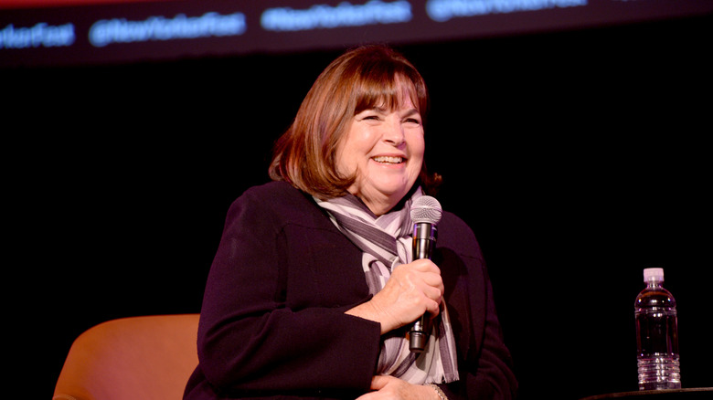 Ina Garten holding a microphone and smiling.