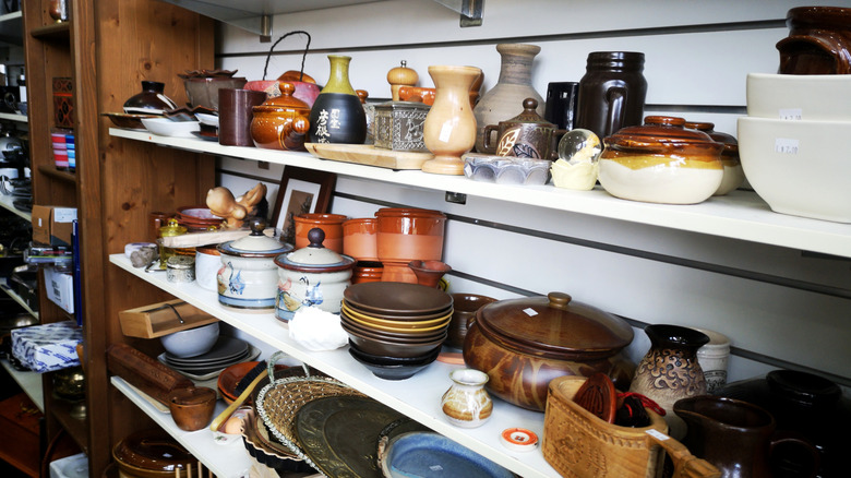 Shelves of pottery and knickknacks at a thrift store
