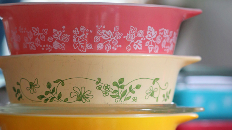 Three colorful pyrex dishes.