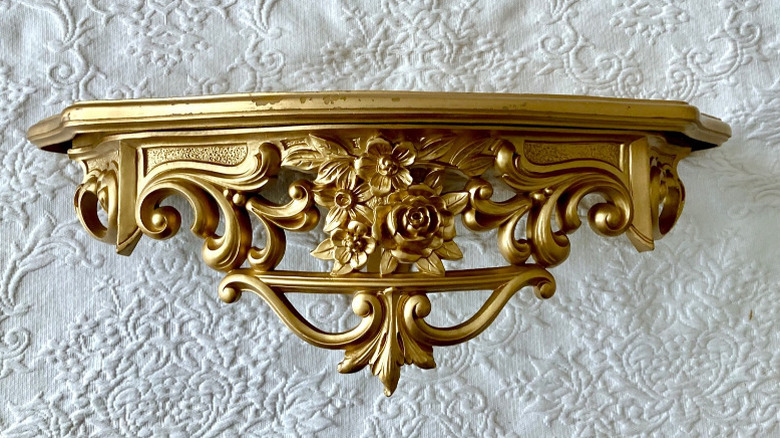 An ornate golden Syroco shelf from the 1960s