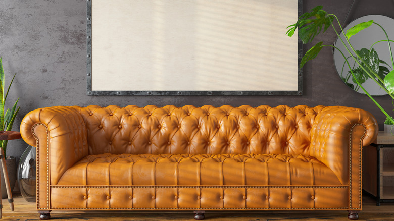 a light brown chesterfield sofa in a a modern space