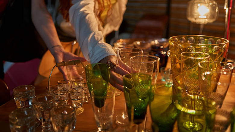 A person examining glassware.