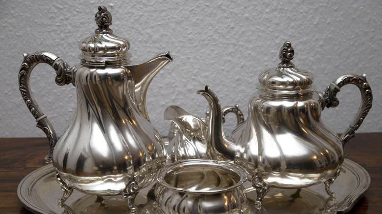 A 4-piece vintage sterling silver tea set on a tray.