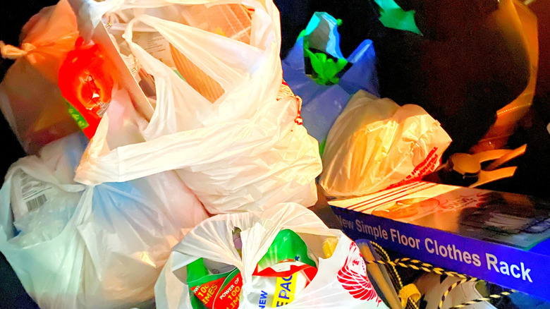 Groceries in plastic bags in a trunk