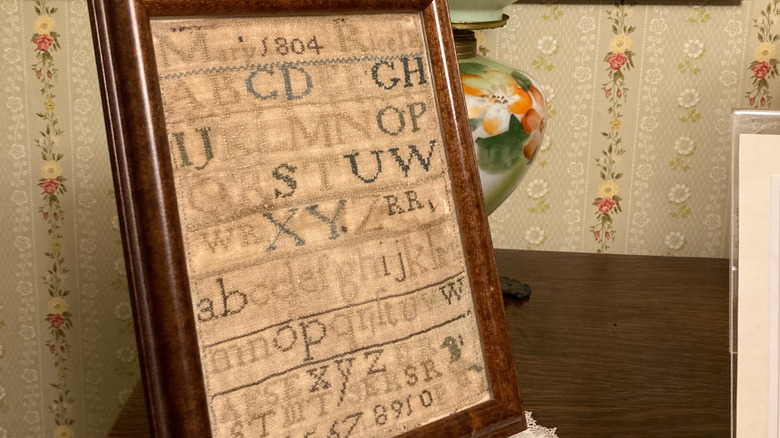 Vintage framed embroidery sampler