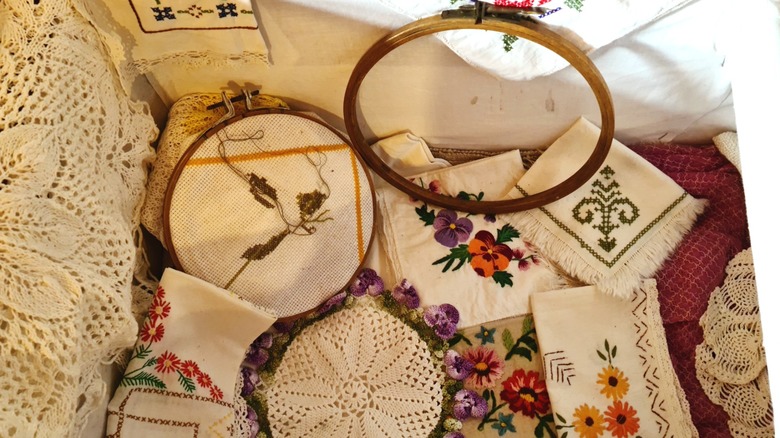 Collection of embroidered pieces at a thrift store