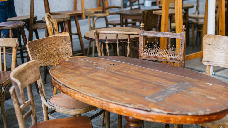 Vintage wooden chairs and a dining table at a flea market.