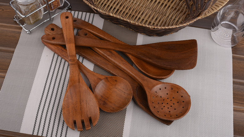 Close up of teak wood utensils sitting on table