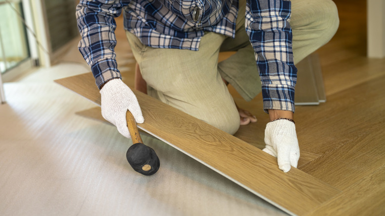Man installing click and lock flooring