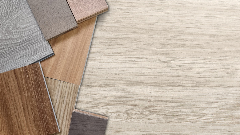 A close up of differently colored vinyl floorboard choices mimicking hardwood