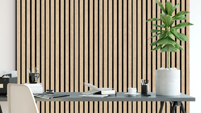 A wood panel accent wall behind a desk.