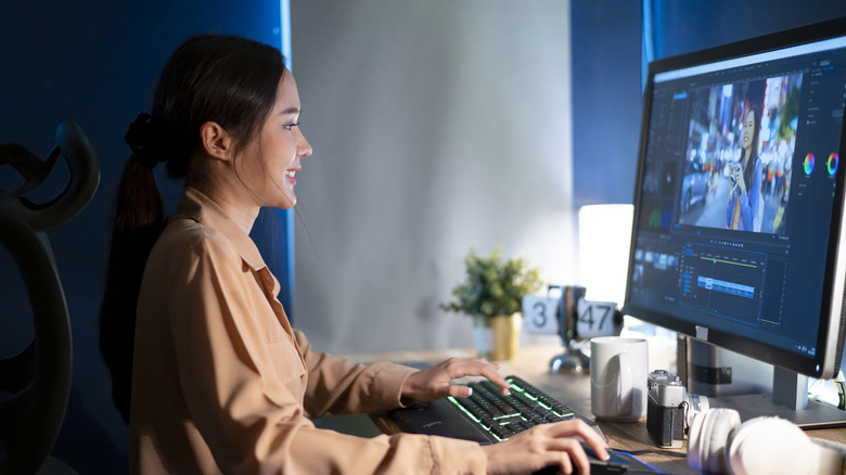 A woman working in a cozy, dimly lit office.