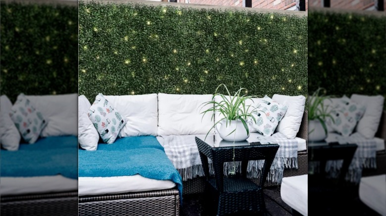 Costco's fake hedge panels with lights installed on a patio.