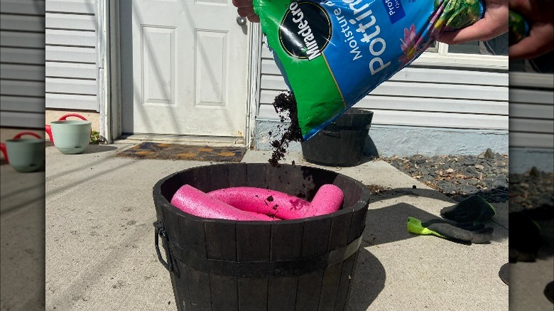Pouring soil onto pool noodles