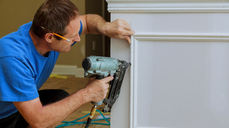 someone installing wall molding