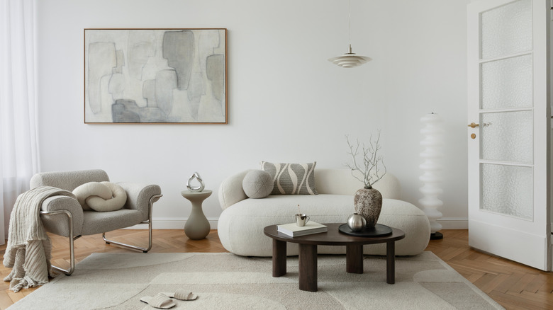 White living room with white sofa and wood coffee table