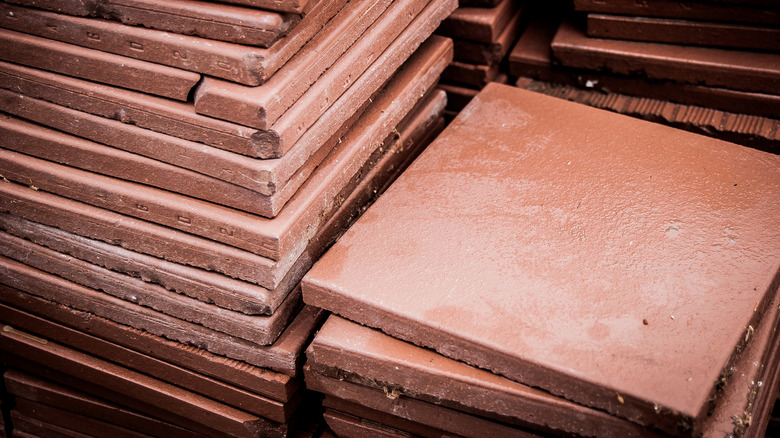 Stack of red quarry floor tiles.