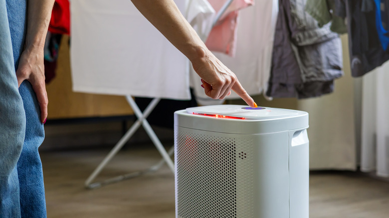 Person using dehumidifier in laundry room