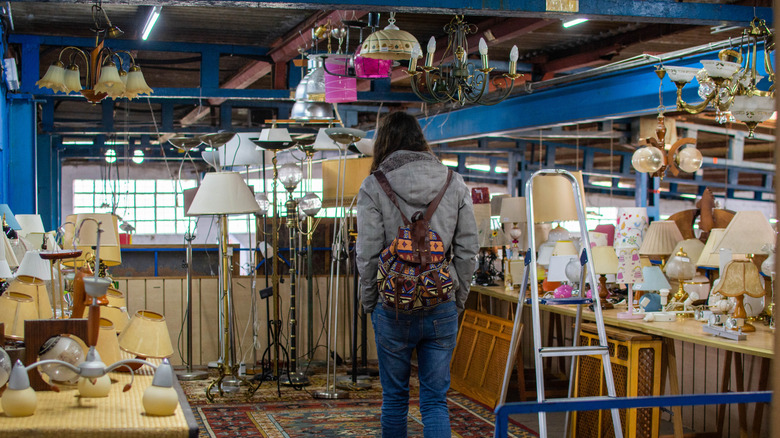 Person shopping for lamps in thrift store