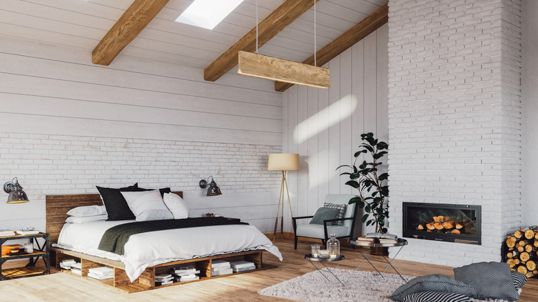 All white bedroom with wood beams