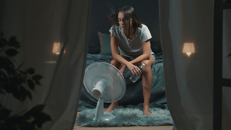 Woman sitting with fan