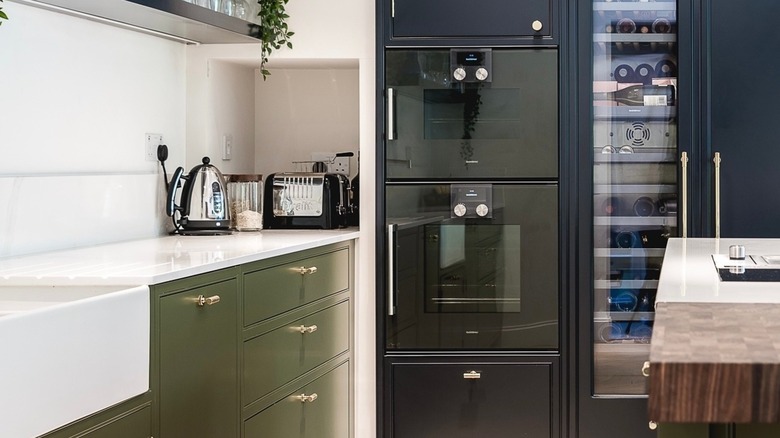 Modern kitchen with green and blue cabinets