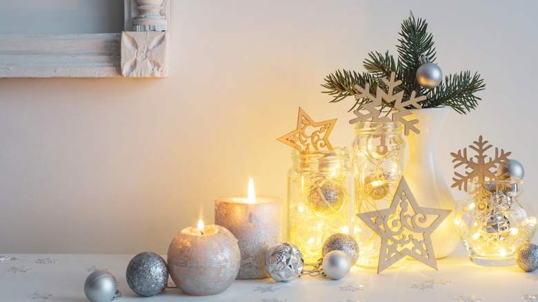winter wonderland decor on a shelf with silver candles and ornaments