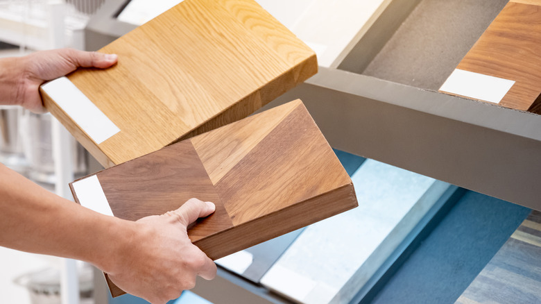 Hands holding two wood samples