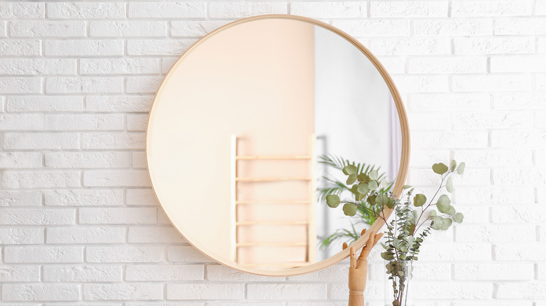 circular mirror on wall 