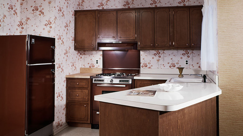 Dark wood cabinets in 1970s kitchen