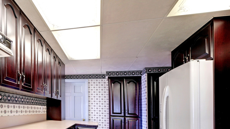 Kitchen with drop ceiling and fluorescent lighting