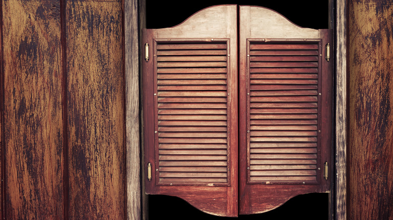 Wood salon doors between paneled walls