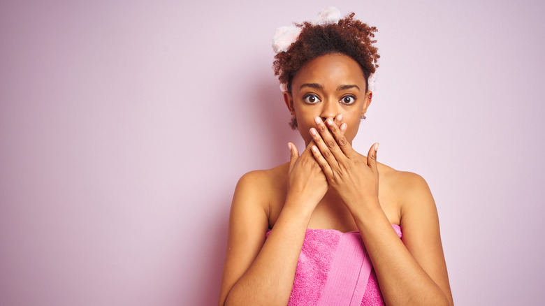 woman in towel is shocked