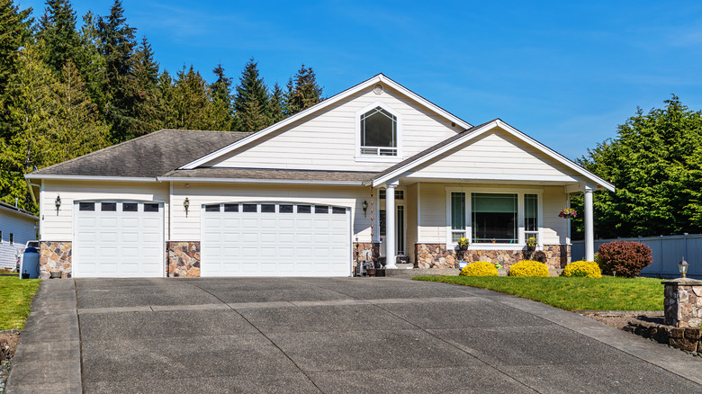 A house and a concrete driveway on a sunny day