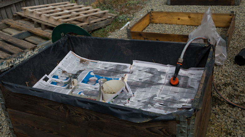 Layers of newspaper in a garden bin