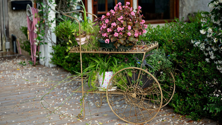 Vintage flower cart displaying pink flowers and greenery