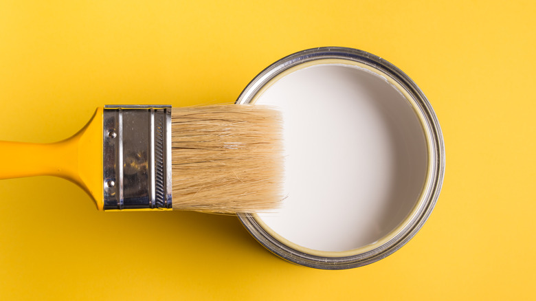 white paint can yellow background