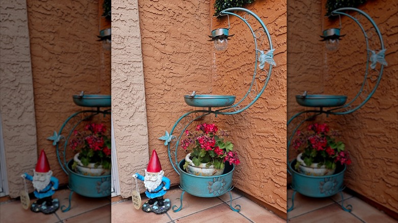 DREAMSOUL's Birdbath with Flower Planter Pedestal with Solar Lamp on patio next to lawn gnome