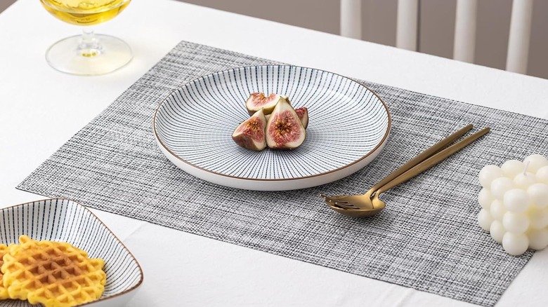 A woven vinyl placemat with a plate of figs.